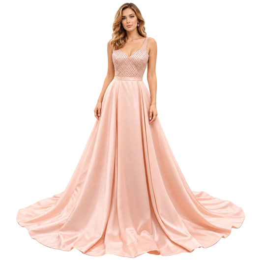 A woman modeling a floor-length formal gown with a peach-pink satin skirt, a beaded lace bodice, and thin straps against a plain white studio background.